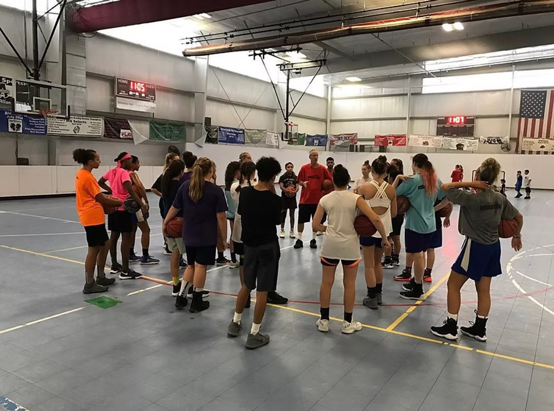 US Hoops players and coaches gather on the court
